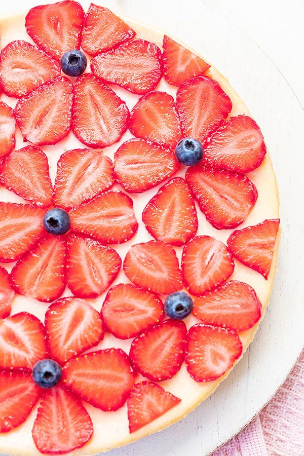 a pizza with strawberries and blueberries on it