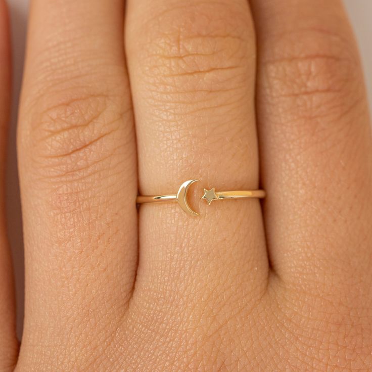 Astrid Just for you, the moon, and the stars. Handcrafted in 14k or 18k solid gold to ensure you never go without them. It is also available in different sizes for the best comfort fit. - Handmade- Solid Gold- Band Thickness: 1.1 mm- Size of the Moon: 4.5 mm- Size of the Star: 2.5 mm All pieces come beautifully boxed in suede pouches you can always use when traveling! Star Gold Ring, Moon Ring Design, Moon Rings, Stars Ring, The Moon And The Stars, Ring Moon, Moon Gold, Middle Finger Ring, Moon And Star Ring