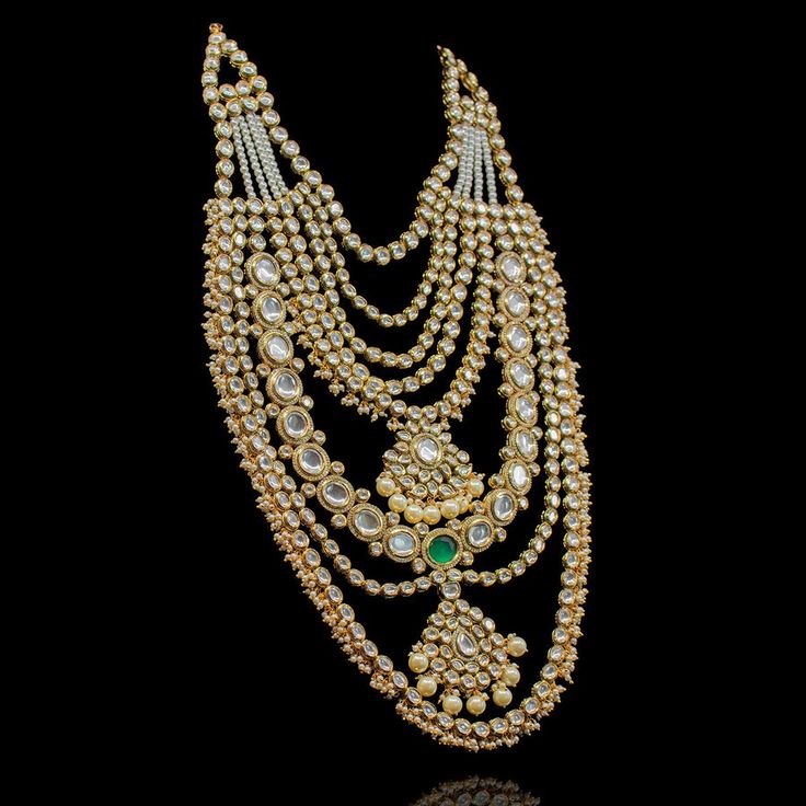 Recreate Priyanka Chopra's iconic wedding mala look, a timeless symbol of love and tradition, for your special day! Royalty-inspired mala heavily laden with kundan stones and an emerald accent that has an old world charm to it. Approximate mala length is 16". Kindly note that the look includes a mala only. Gold-plated