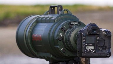 a camera attached to a tripod in front of a body of water