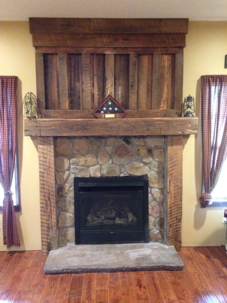 a living room with a fire place and wood flooring in front of the fireplace