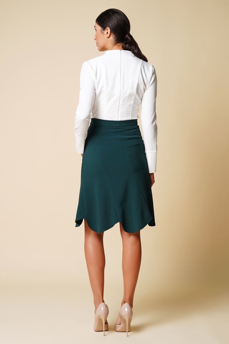 "A green skirt featuring a high-rise styling, midi length, and a trumpet silhouette. - high waist - trumpet silhouette - knee midi length - concealed back zipper closure - godet style Color: dark green Fabric: viscose - 40%, elastane - 5%, polyester - 55%. Our model wears size S (US 6) and is 178 cm / 5'8\" tall. MORE ITEMS: https://www.etsy.com/shop/TAVROVSKA?ref=hdr_shop_menu SIZE CHART XS __ EU 32 __ US 2 bust: 31,5\" | 77 cm waist: 24,5\" | 59 cm hips: 34,5\" | 84 cm XS __ EU 34 __ US 4 bust Fitted Ruffled Midi Skirt, Green Flared Skirt For Formal Occasions, Fitted Flared Mini Skirt For Office, Green Flowy Formal Skirt, Formal Green Flowy Skirt, Elegant Green Stretch Mini Skirt, Green Midi Length Workwear Bottoms, Fitted Knee-length Ruffled Mini Skirt, Elegant Midi Pencil Skirt With Ruffle