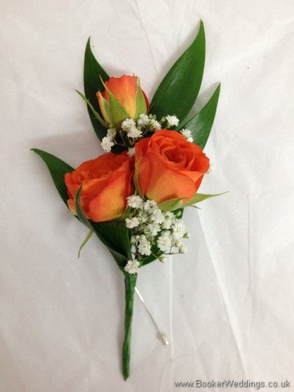 three orange roses and baby's breath on a white background with green leaves in the center