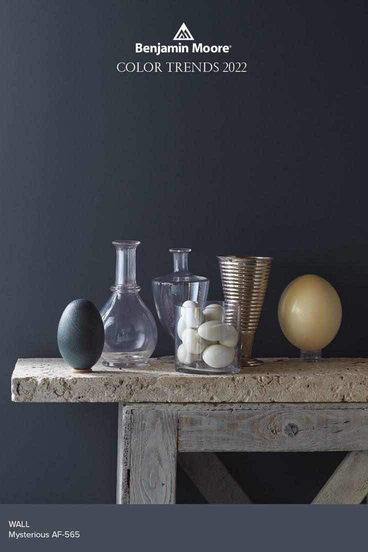 an assortment of vases sitting on top of a wooden table