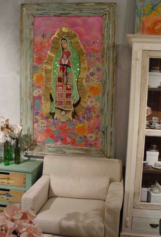 a living room filled with furniture and a painting on the wall over a chair in front of it