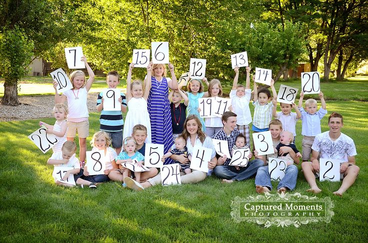 a group of children holding up numbers in the grass