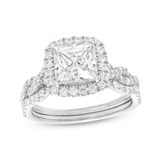 an engagement ring set with a princess cut diamond in the center and two rows of pave