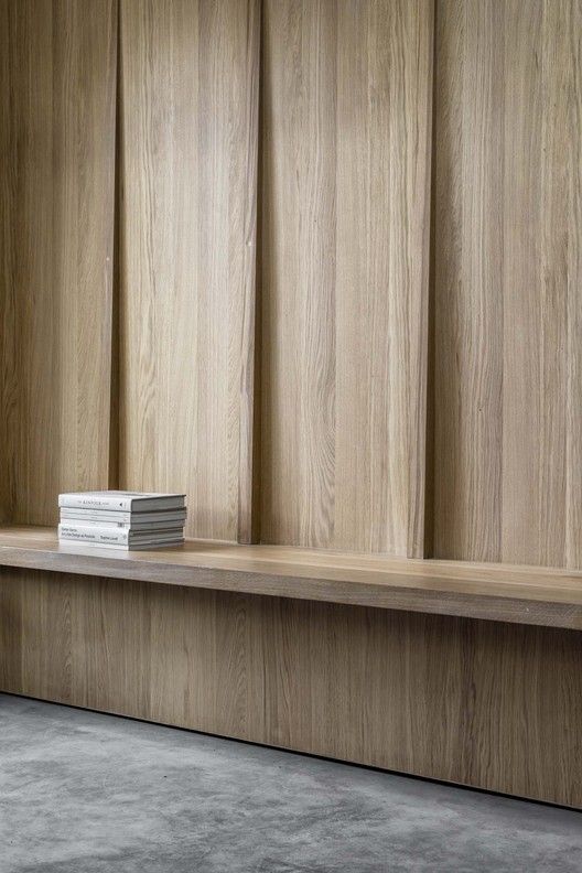 a stack of books sitting on top of a wooden shelf