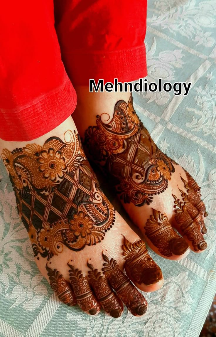 the feet are decorated with henna designs