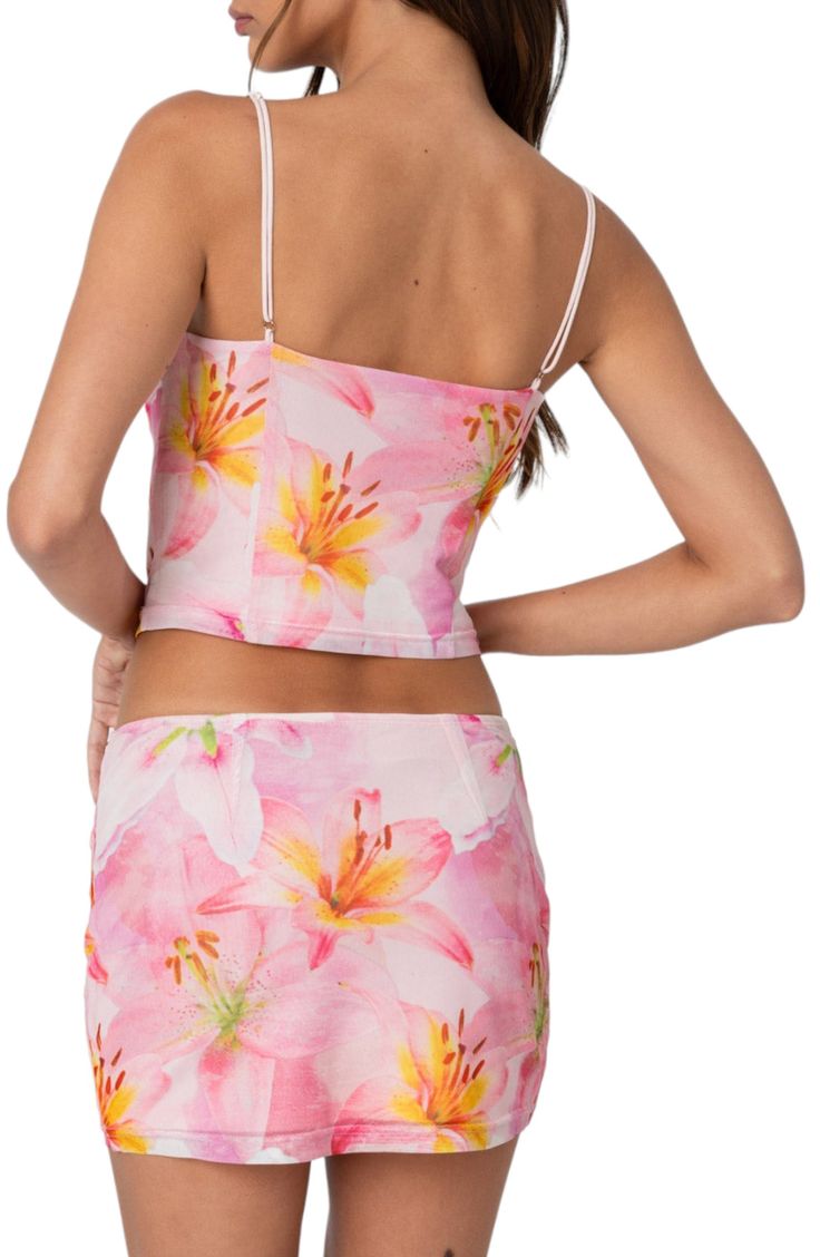 A subtle cowl neckline begins this stretchy figure-hugging crop top awash in a floral print. Cowl neck Spaghetti straps 100% polyester Machine wash, dry flat Imported Fitted Printed Camisole With Spaghetti Straps, Fitted Printed Summer Camisole, Fitted Floral Print Camisole With Spaghetti Straps, Fitted Elastane Summer Camisole, Cropped Elastane Tank Top For Summer, Summer Cami Crop Top In Elastane, Fitted Spaghetti Strap Crop Top, Fitted Elastane Crop Top With Spaghetti Straps, Summer Scoop Neck Elastane Crop Top