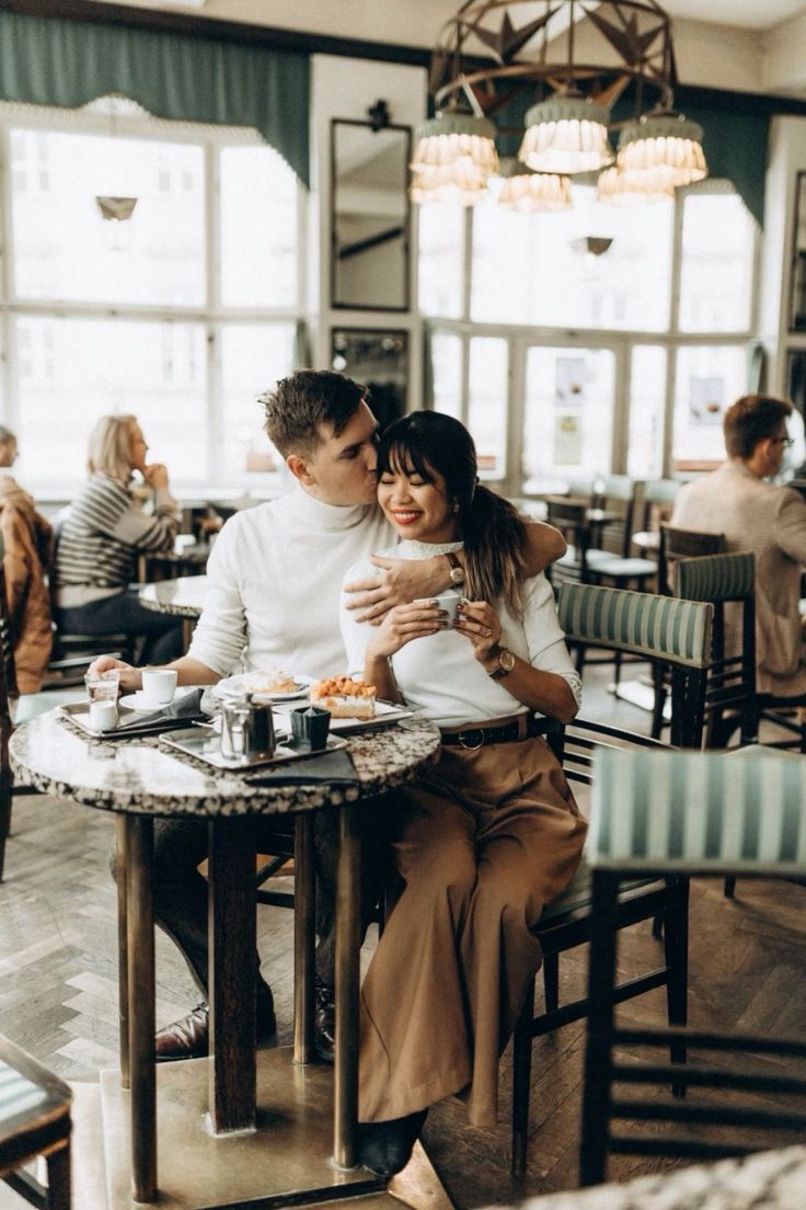 a man and woman sitting at a table in a restaurant