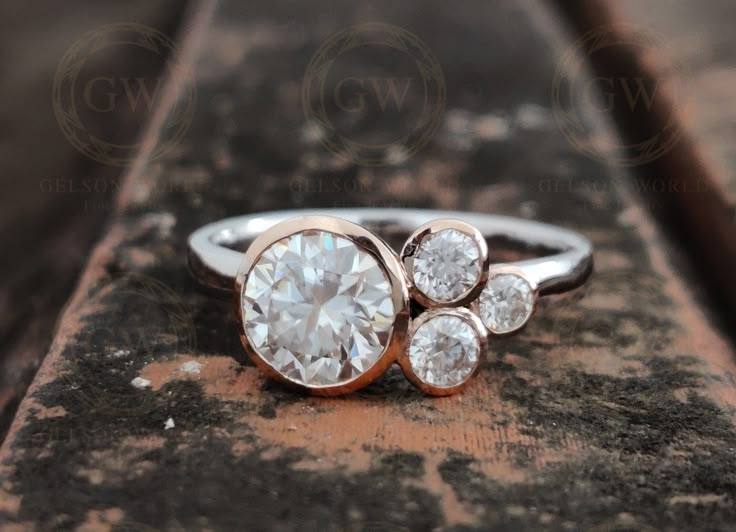 a diamond ring sitting on top of a wooden surface