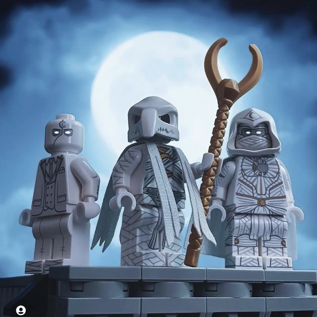 three lego figures standing on top of a building with a sceptacle and hammer in their hands