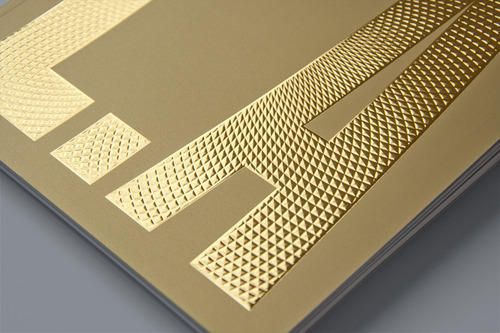 the back side of a book with gold foil on it