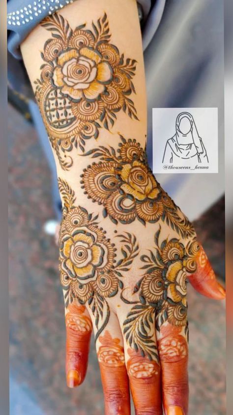 a woman's hand with henna tattoos on it