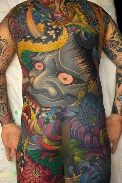 a man with lots of tattoos on his body