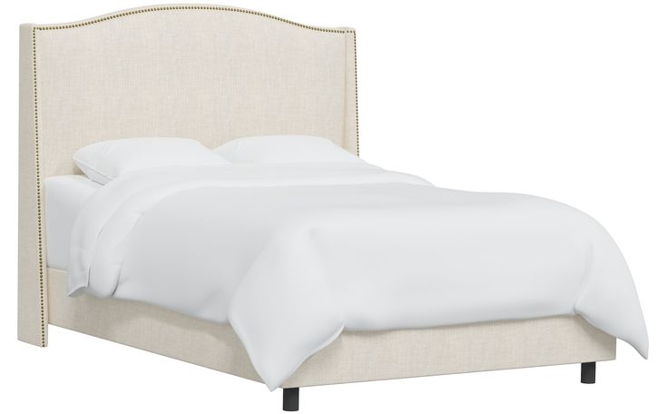 the headboard and foot board of a bed with white linens on top of it