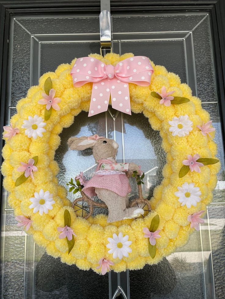 a yellow wreath with a bunny on it