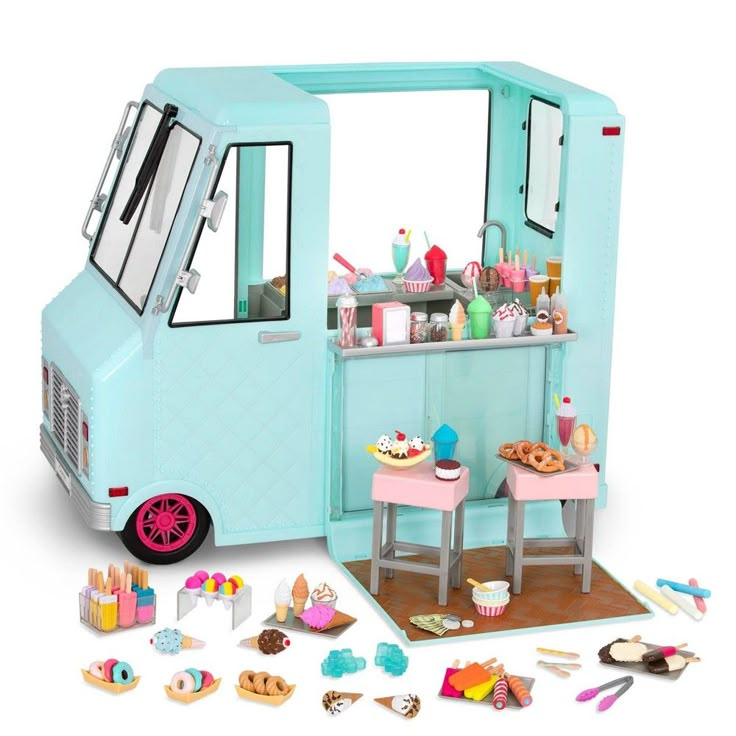 a toy ice cream truck with lots of food on the table and in front of it