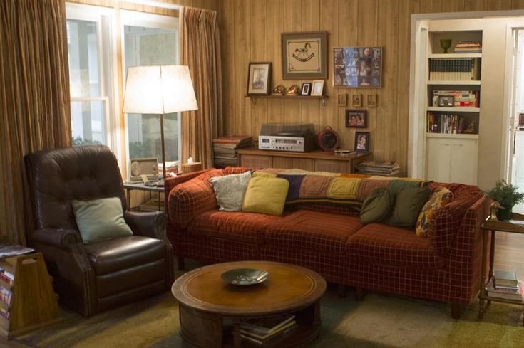 a living room filled with furniture next to a window