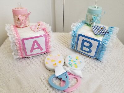 two baby shower items on a table with the letters abc and person spelled out next to them