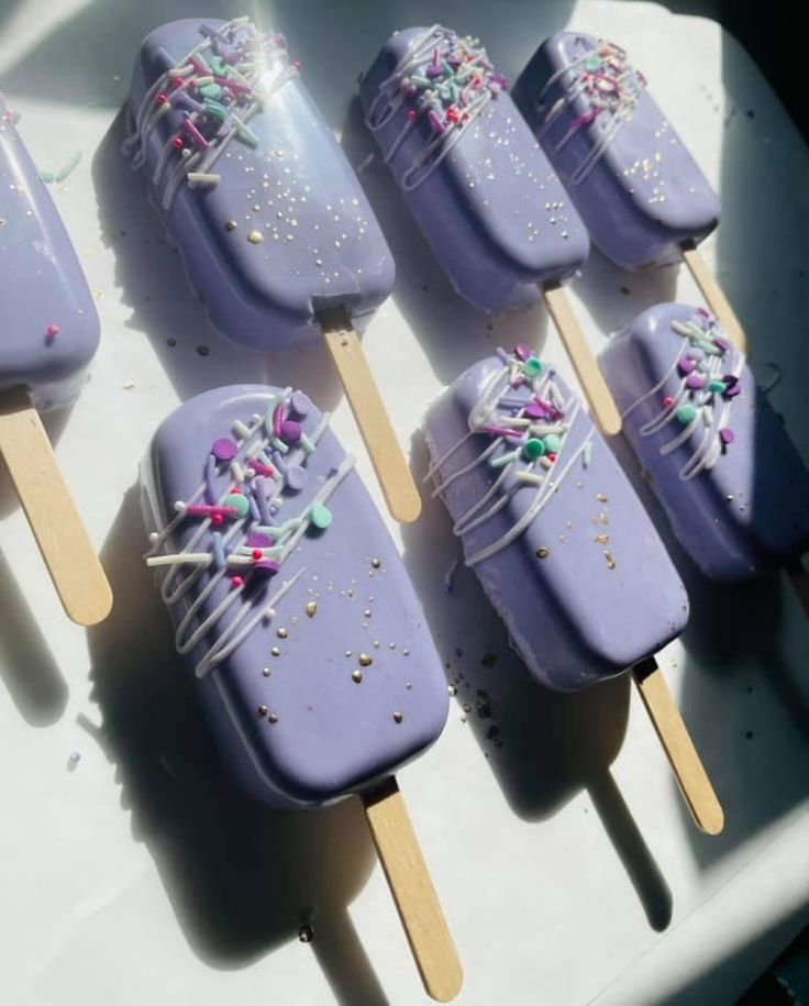 purple ice cream pops with sprinkles on them