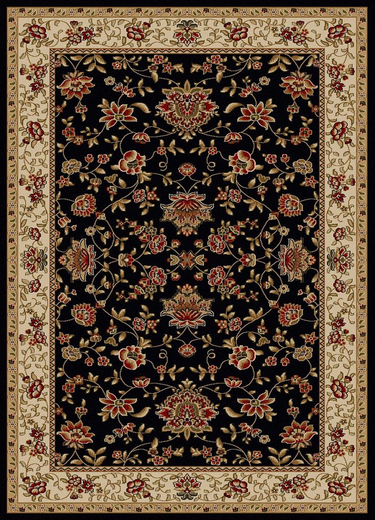 a black rug with red and white flowers on it's border, in the middle of