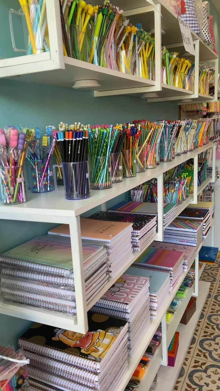 the shelves are filled with many different colored papers