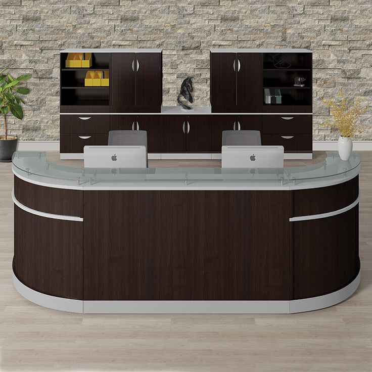 an office counter with two sinks and cabinets in front of a brick wall behind it