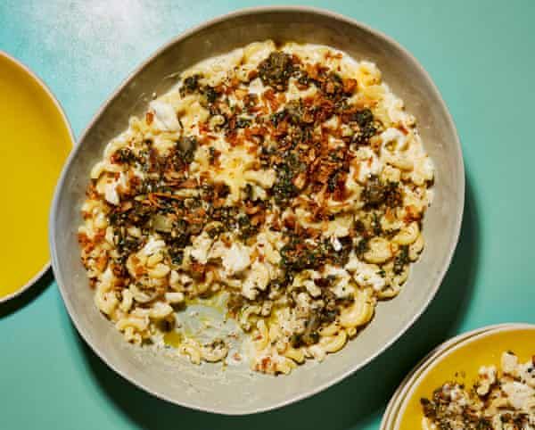 a bowl filled with food next to two yellow plates