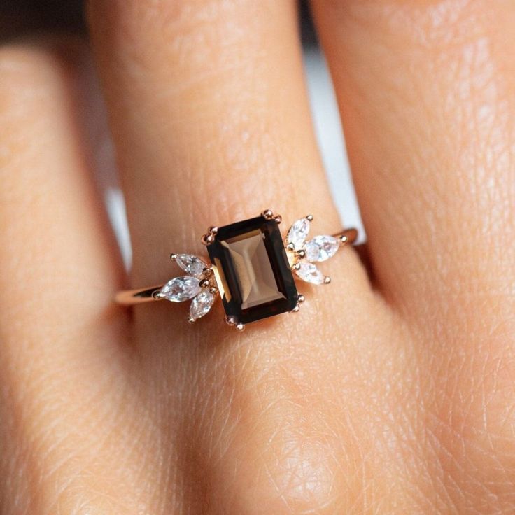 a woman's hand with a ring on it and a stone in the middle