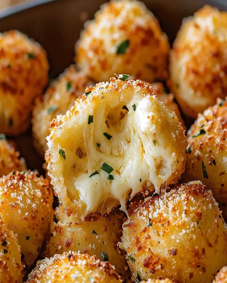 a close up of some food in a pan with cheese on top and parmesan sprinkles