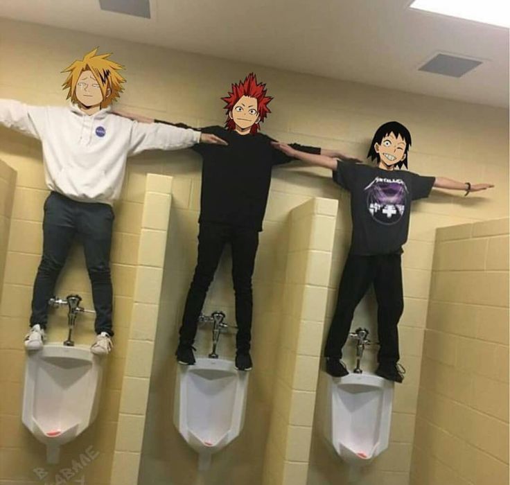 three people standing on urinals in a bathroom