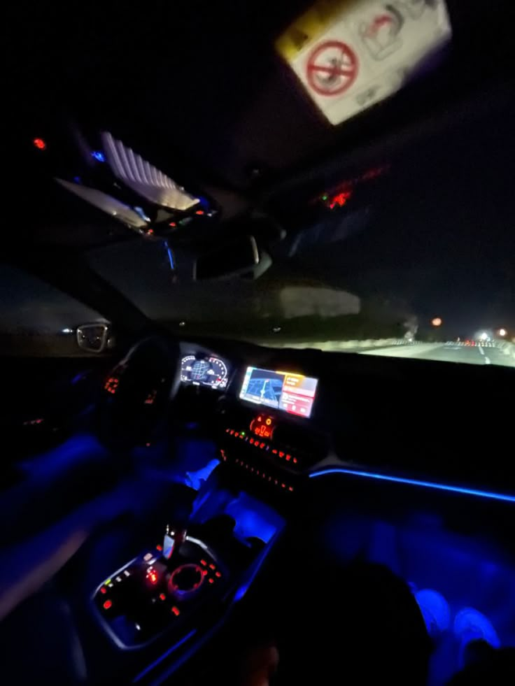 the interior of a car with blue lights