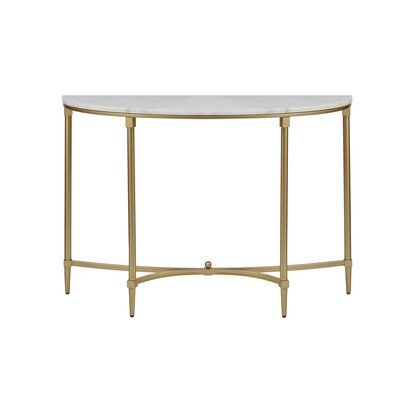 a white marble top table with gold metal legs and an oval shaped design on the bottom