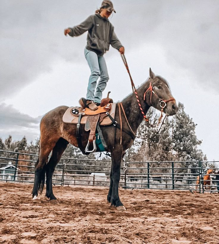 a man riding on the back of a brown horse