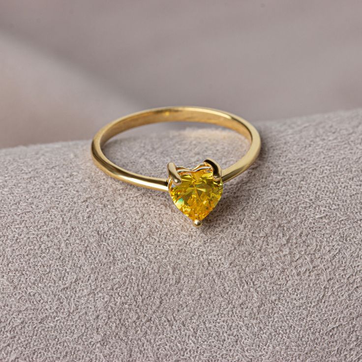 Yellow topaz is believed to bring joy, abundance and health. We crowned the heart symbol, which is a symbol of love, friendship and many other affections, with precious stones. Now you can see the love at your finger. Other Products Compatible with Our Yellow Topaz Heart Ring: https://artdiamonds.etsy.com/listing/1391167870/yellow-topaz-heart-necklace14k-solid?utm_source=Copy&utm_medium=ListingManager&utm_campaign=Share&utm_term=so.lmsm&share_time=1694013680759 F E A T U R E S * Made to Order. * Gold KT: 14K * Gold Color: Yellow Gold, Rose Gold, White Gold * Yellow Topaz Carat: 1.00 ct. * Stone Height: 7,12 mm / 0.28 inch * Stone Width: 6,12 mm / 0.24 inch * Setting Type: Bezel Setting * Ready to Ship in 1-3 Business Days * 100% US sourced * 2 Years Warranty * Free Express International Sh Gift Yellow Gold Topaz Ring With Cubic Zirconia, Yellow Gold Topaz Birthstone Ring For Gift, Yellow Gold Topaz Ring With Cubic Zirconia For Gift, Yellow Gold Topaz Birthstone Ring As Gift, Yellow Topaz Promise Ring In 14k Gold, Yellow Gold Topaz Crystal Ring As Gift, Citrine Birthstone Diamond Ring Gift, Gift Citrine Birthstone Diamond Ring, Yellow Crystal Birthstone Ring For Promise