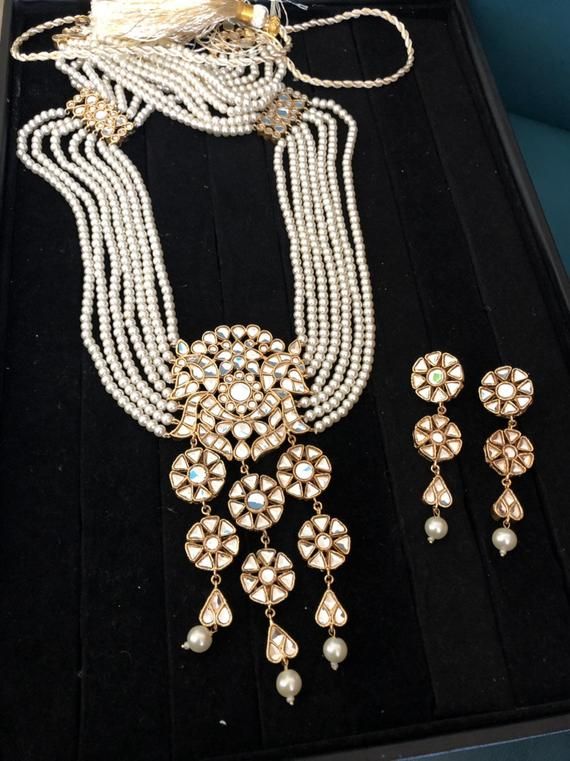 Get your special look on point with this exquisite gold plated high quality kundan mala and earrings.Made to order and ready to ship in 4 to 6 weeks. White Kundan Jewelry For Party, White Kundan Party Jewelry, Traditional White Designer Jewelry, Bollywood Style Gold Plated Kundan Necklace With Cutdana, Kundan Long Necklace Temple Jewelry, White Kundan Necklace With Mirror Work, Elegant White Designer Jewelry, White Kundan Chandbali Jewelry, Kundan Bridal Necklace With Stone Work