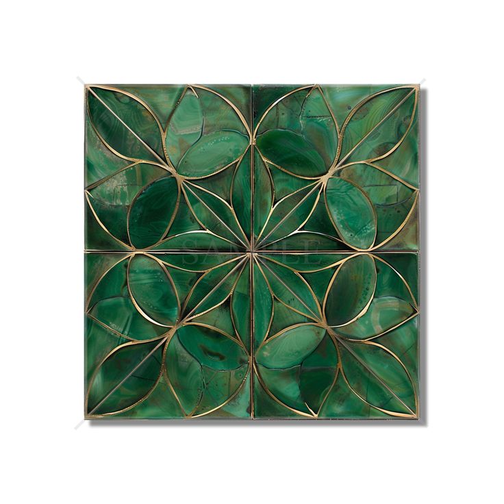 a green tile with gold leaf designs on it