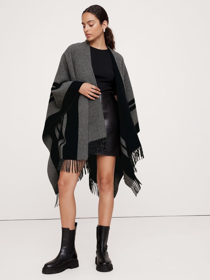 Reach for this warm poncho when one layer just isn't enough.  Crafted from luxurious wool, this striped poncho adds an unexpected pop of bold detail.  Length: 62" Width: 56"