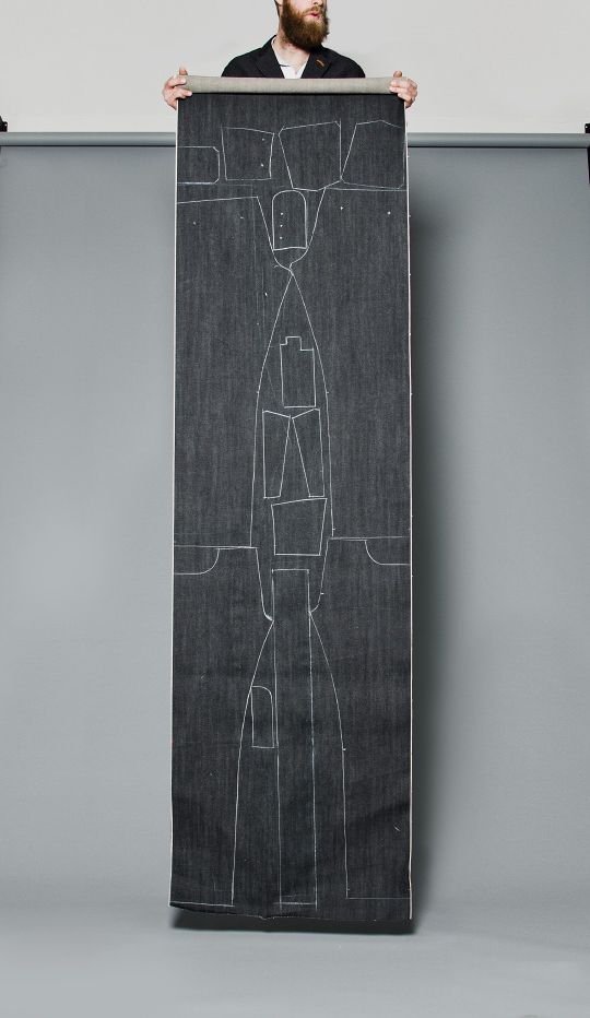 a man holding up a black and white drawing