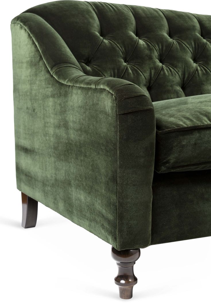 a green velvet couch with wooden legs and buttons on the arm, viewed from the front