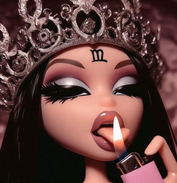 a doll wearing a tiara and holding a lighter in her hand with the candle lit