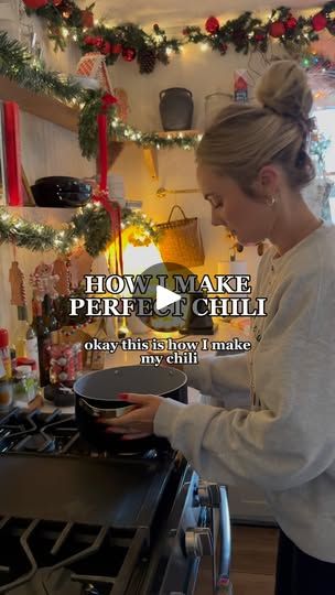 a woman is cooking in the kitchen with christmas decorations