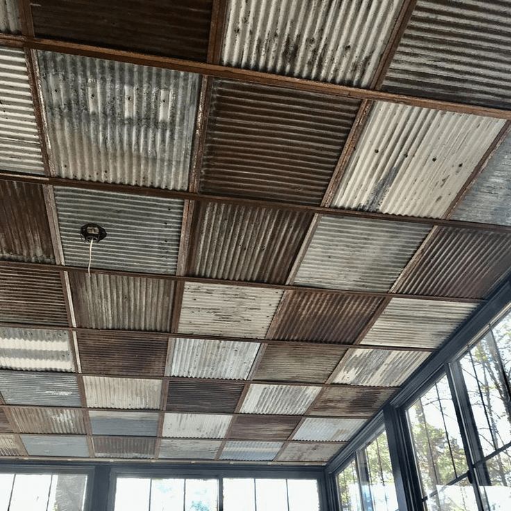 an old tin ceiling with windows in the background