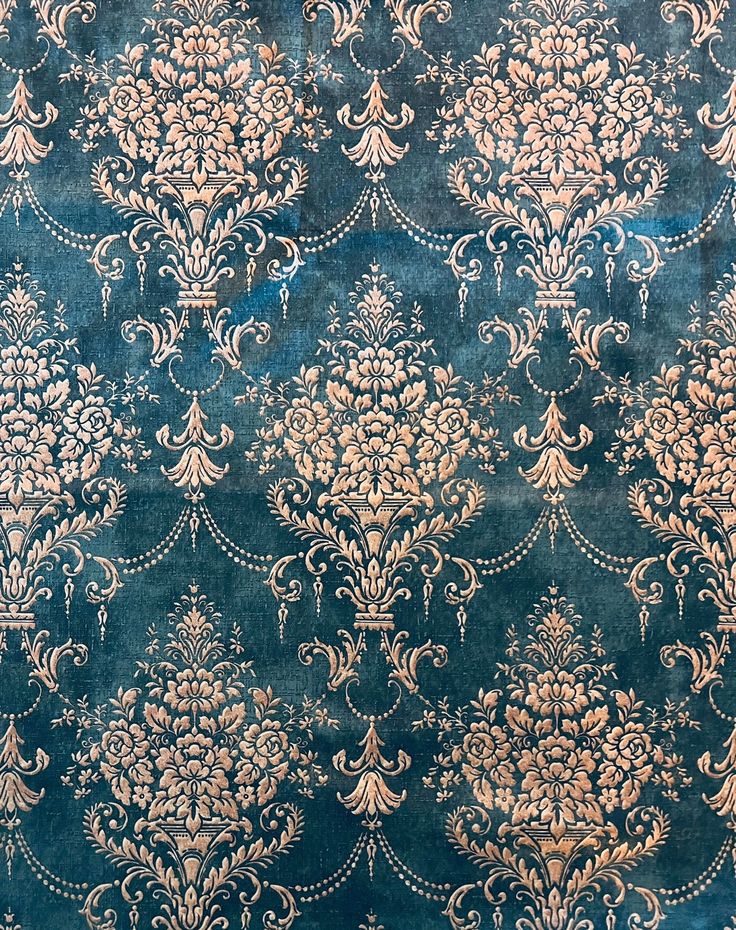 an old blue and gold wallpaper with ornate designs on it's surface,