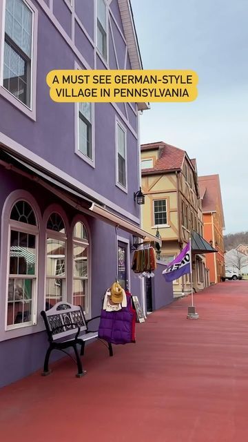 a bench sitting in front of a purple building