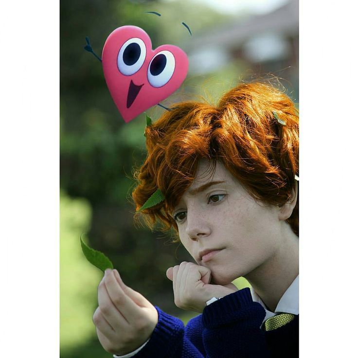 a girl with red hair and an odd heart on her head, holding a leaf