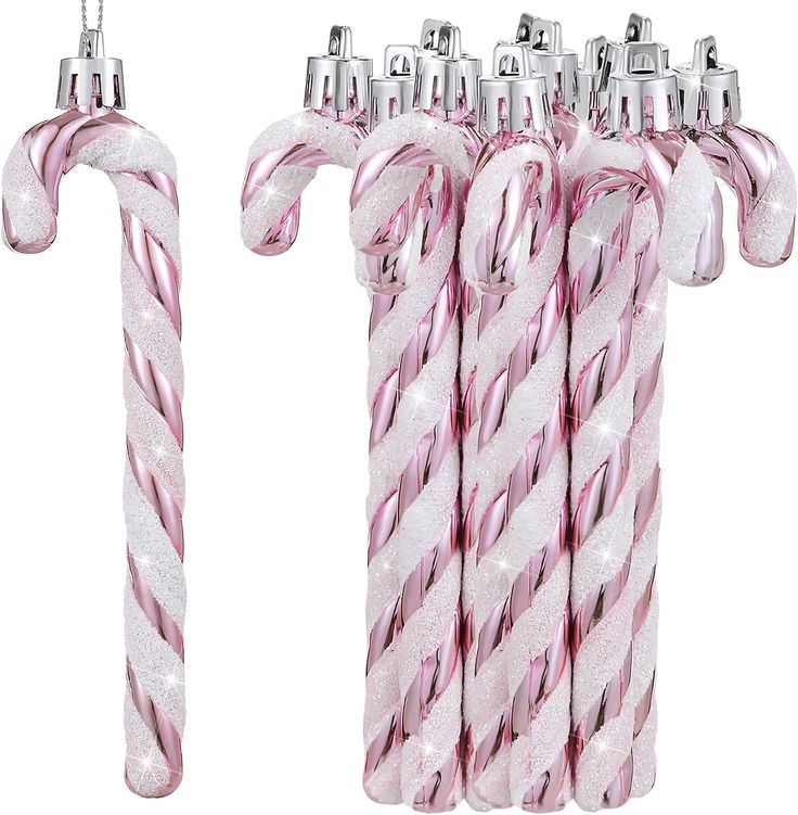 three candy canes are shown in pink and white colors with silver decorations on them