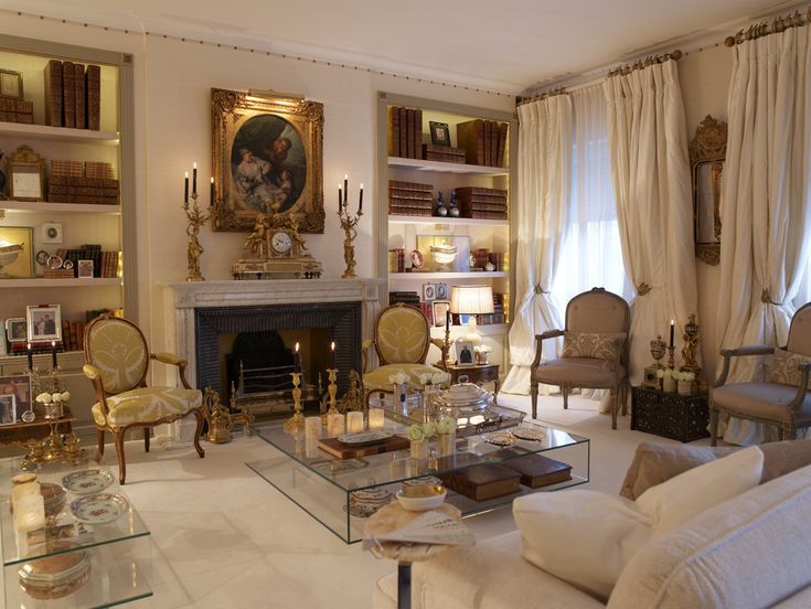 a living room filled with furniture and a fire place in the middle of a room